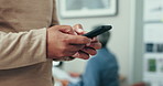 Man, hands and walking with phone in office for social network, business contact and online chat. Closeup, employee and typing on smartphone, digital software or search mobile app in coworking agency