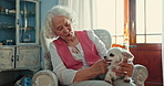 Senior woman, couch and dog in home with playing, memory or thinking for care, love and stroke fur. Elderly person, pet or animal in house, retirement or peace for calm with talk, kindness and happy