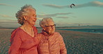 Conversation, beach and senior women friends on retirement vacation, adventure or holiday together. Happy, travel and elderly people with reflection, memory or thinking by ocean on weekend trip.