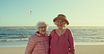 Happy senior women, friends and beach with hug, face and vacation in summer, sunshine and freedom. People, retirement and embrace in portrait by ocean, holiday or relax outdoor on adventure in Naples