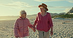 Senior women, friends and holding hands at beach for talk, love or vacation for care, summer or freedom. People, retirement and conversation in nature, holiday and relax outdoor with memory in Naples