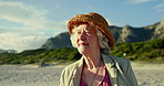 Beach, nature and elderly woman with vacation, smile and journey with sunshine, retirement and peace. Wellness, view and outdoor with pensioner, senior lady or summer with seaside, fresh air or break