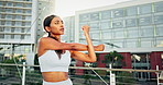 Woman, fitness and stretching in city getting ready for workout, exercise or outdoor training. Active female person, athlete or runner in warm up arm stretch for preparation in wellness at urban town