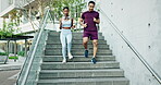 Couple of friends, running and fitness on stairs for workout, training and race with cardio health and teamwork in city. Young woman, man and personal trainer or runner for outdoor exercise in sports