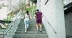 Couple of friends, running and workout on stairs for training, fitness and race with cardio health and teamwork in city. Back of sports people, runner or personal trainer on steps or outdoor exercise