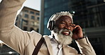 Happy, dancing and senior businessman with headphones in the city walking and listening to music. Smile, happy and elderly African male person streaming playlist, song or radio commuting in town.