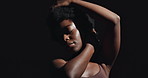 Face, hands and beauty with a black woman on a dark background in studio for feminine wellness. Arms, skincare and natural with a confident model touching her body or aesthetic skin in satisfaction