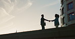 Business people, handshake and outdoor silhouette for partnership, introduction and travel meeting in city. Professional clients or advisor shaking hands for welcome, hello and consulting in b2b deal