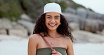 Woman, face and walking on beach, smiling and comedy in outdoors or travel to ocean for fun. Happy female person, portrait and laughing for humor in nature, freedom and relaxing on holiday or getaway