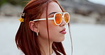 Woman on beach with sunglasses, face and thinking in nature, vacation and freedom while looking at view. Dream in  fashion accessories for summer, young with inspiration and ideas for travel 