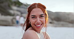 Woman, face and relaxing on beach vacation, smiling and happy in outdoors or travel to ocean for fun. Female person, portrait and satisfaction or free in nature, peace and calm on holiday or getaway