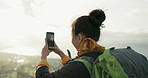 Woman, hiking and phone for photography on mountain, back and memory with view, landscape and adventure. Photographer girl, outdoor and smartphone screen on hill, fitness and wellness on social media