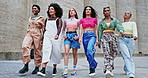 Women walking with confidence, fashion and friends outdoor with streetwear and sneakers. Young model group, trendy and stylish clothing in urban city, beauty and casual outfit with comfort and edgy