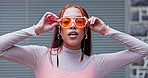 Sunglasses, face or woman in city with fashion, urban style and cool clothes with attitude or swag. Outdoor, travel or confident girl on holiday vacation with trendy hair, freedom and pride in town 