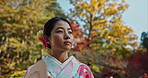 Woman in garden, Asian and calm with fan, thinking about life with reflection and tranquility in traditional clothes. Peace Japanese park and nature for fresh air with inspiration or insight