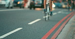 Closeup of a person cycling through a busy city