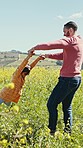 Father, girl child and spinning in grass field on vacation, holiday or adventure with happiness and fun. Family, man and daughter swinging in circle for bond, relax and outdoor in summer with smile