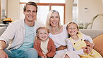 Happy, parents and face of children on sofa in home for bonding, relationship and relax together. Family, living room and portrait of mother, father and kids for love, care and embrace on couch