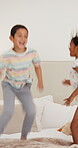 Children, bed and jumping for sibling fun in morning together for bonding or holiday connection, play or excited. Kids, leap and linen duvet or happiness in apartment for development, game or weekend