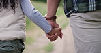 Person, child and holding hands in nature for outdoor explore safety or support, adventure or vacation. Parent, kid and back view on forest path for hiking travel for holiday, exercise or trekking