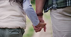 Person, child and holding hands in nature for trekking explore safety or support, adventure or vacation. Parent, kid and back view on forest path for hiking travel for holiday, exercise or journey