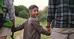 Family, holding hands and hiking in forest for bonding and fresh air, happiness with parents and child outdoor. Nature, environment and people in park, trekking and travel with adventure and freedom