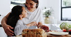 Mother, child and hug in kitchen by healthy food, love and cooking lesson at home for bonding. Woman, hands and girl for vegan salad by tomato, care embrace and making sandwich together on weekend