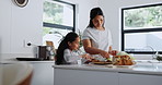 Mother, child and sandwich in kitchen for breakfast, healthy food and cooking lesson at home for bonding. Woman, girl or butter on raisin bread by vegetables, together or care in nutrition on weekend