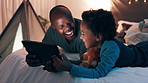 Happy father, child and tablet at night on bed for online streaming, entertainment or watching movie at home. African dad, kid or son smile with technology for movie, funny show or cartoon in bedroom