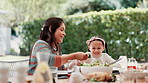 Family, thanksgiving vegetables and mother with daughter at table outdoor for celebration or tradition. Love, food or lunch with woman parent and girl child eating meal together at social gathering