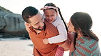 Beach, parents and kid on shoulders of father for adventure, playing or bonding together. Happy, sunset and girl child with young mom and dad by ocean on tropical vacation, holiday or weekend trip.