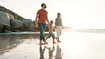 Beach, walking and child holding hands with parents for adventure, fun or bonding together. Happy, sunset and boy kid with young mom and dad by ocean on tropical vacation, holiday or weekend trip.