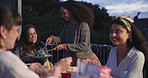 Friends, food and patio with dinner party, event and discussion on a holiday at night. Happy, people and conversation outdoor with a meal, plate and celebration for usa pride and communication