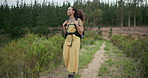 Woman, walking in woods for hiking and adventure outdoor with backpack, peace and calm for travel. Trekking, journey and fitness, health and wellness with sightseeing in nature park with environment