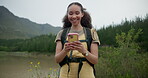 Woman, hiking in woods and smartphone for social media and adventure outdoor with backpack, chat and tech. Trekking, journey and travel, communication and happy influencer with online update on app