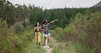 Friends, women in woods and hiking in nature, point at view while walking and travel together. Adventure, journey and fitness, sightseeing in forest or park for tourism, environment and backpacking