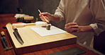 Sushi, fish and closeup of chef hands cooking on table at diner, cuisine or restaurant at night. Kitchen, career and zoom of culinary artist preparing a gourmet Japanese meal or snack at catering job