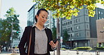 Cellphone, walking and business woman in the city networking on social media, mobile app or internet. Technology, street and professional Asian female person with phone commuting in street in town.