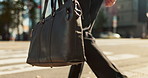 Walking, city and business person with bag for career, job and professional work in urban town. Morning commute, travel and closeup of legs of worker with luggage for journey to office building