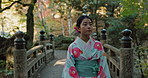 Walking, thinking or Asian woman in garden for journey on holiday vacation for freedom or wellness. Bridge, travel or Japanese person with ideas for calm, peace and inspiration to relax in forest