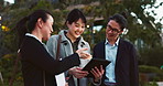 Tablet, discussion and business people in the city talking for communication or bonding. Smile, conversation and professional Asian colleagues speaking with digital technology in urban town.