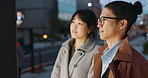 Conversation, night and young Asian couple in the city for travel, adventure or journey together. Communication, happy and man and woman talking by board for commuting in urban town in evening.