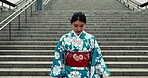 Japan, woman and walk in kimono on stairs, city and travel for heritage celebration or holiday. Young person, happy or traditional clothes in tokyo with beauty, culture and pride in japanese fashion