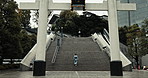 Traditional shinto woman, stairs and torii gate on walk at temple for faith, spiritual journey or zen reflection. Japanese person, steps and outdoor with culture, indigenous clothes and back in Tokyo