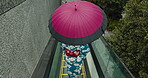 Japanese woman, umbrella and kimono in city, escalator ride and wellness for heritage celebration. Young person, relax and traditional clothes in tokyo in town, color and pride for fashion in outdoor