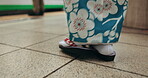 Japan, feet and walking in temple in kimono, worship and woman in prayer for spiritual development. Person, slippers and traditional clothes in tokyo religion and mindfulness in sandals for culture