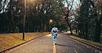 Nature, walking and woman in the park at night for sightseeing, adventure or journey. Travel, street and back of Japanese female person in kimono commuting in outdoor garden in Tokyo on weekend trip.