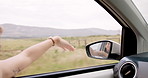 Woman, hand and wave by window for road trip, car or wind with speed, driving or travel in countryside. Girl, person and happy for vacation, vehicle and transportation with mirror, field or freedom