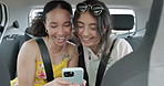 Happy friends, phone and car for road trip information, location search and social media. Young women reading on mobile app and talking of travel, holiday and transportation service with funny chat