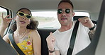 Singing, dancing and couple in car on road trip in countryside listening to music together. Happy, love and young man and woman moving to song, playlist or radio in vehicle on holiday or adventure.